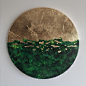 This may contain: a green and gold painting on a white wall