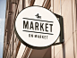 The Market On Market Logo : This logo was designed to emulate the rustic, simple, down to earth feelings conjured up at a traditional outdoor market. It is by design part street sign (for Market St., Where it's located), part stamp like the markings you'd