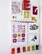 A colourful arrangement of pictures and hooks on a child's bedroom wall