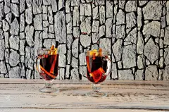 木桌上放着两杯加了香料的热葡萄酒。