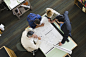 Multi-ethnic architects looking at blueprints by Gable Denims on 500px