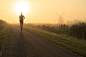 Running @ windmill : Man running in the foggy, Dutch countryside near a traditional windmill just after sunrise.