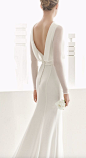 Sleek long-sleeve white wedding dress with low draped back design; Featured Dress: Rosa Clara: 