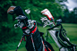 A macro shot of golf club bags sitting off to the side on a real golf course