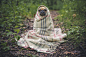 Portrait of French bulldog wrapped in blanket on forest path