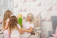 母亲节快乐!女儿们会在她们家粉红色的客厅里送给妈妈一张明信片和一束郁金香来祝贺她。为生日或国际妇女节