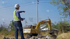 土建工程师在挖土机工作时进行现场检查