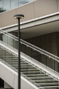 This may contain: an escalator and lamp post in front of a building