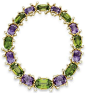 An amethyst, peridot and diamond necklace, by Veronique Cartier. Designed as a graduated alternating series of cushion-cut amethysts and peridot, spaced by sculpted 18k gold twist links, bezel-set with pear-shaped diamond terminals, mounted in gold, circa