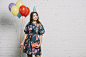 portrait-birthday-girl-holding-balloons-gift-box-looking-away