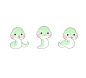three little green sea animals sitting next to each other on a white surface with pink cheeks
