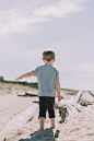 boy standing on sand