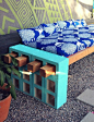 With a few long pieces of wood, you can also use cinder blocks to create an impromptu couch.