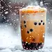 冬天雪花纷飞中一杯珍珠奶茶特写图片
