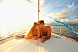 Caucasian couple sunbathing on yacht deck by Gable Denims on 500px