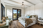 Inspiration for a mid-sized country guest medium tone wood floor and brown floor bedroom remodel in Other with white walls