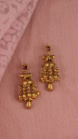 Tiered gold earrings accented with the vibrance of a pink stone