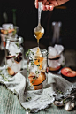 Making plum cocktail with apricot syrup and prosecco