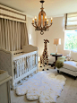 Example of a small classic gender-neutral dark wood floor nursery design in Los Angeles with beige walls