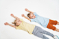Children are lying on the floor a boy and a girl pull the handles up children in sportswear children...