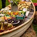 A delightful and functional display idea from Simple Bites: present your outdoor buffet in an old canoe, accented with pretty wildflowers.: 