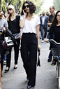 pleated pants & white tee, curly bob and oversized sunnies with burgundy glossed lips: 