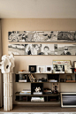This may contain: a living room filled with furniture and paintings on the wall