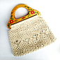 Vintage 1970's Macrame Handbag with Floral Painted Wooden Handles : This super retro handbag was made with white cotton twine and is knotted in a decorative macrame design. It features floral milk glass round beads on the front of the purse and the handle