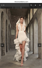 This may contain: a model walks down the runway in a white dress with ruffles on it