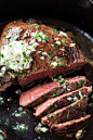 Cooking a steak in a cast-iron skillet.