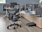 Contemporary office setting with hardwood floor using Locale workstations with two new Aeron Chairs in Carbon finish