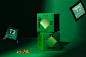 This may contain: two green boxes sitting on top of each other next to a pile of gold coins