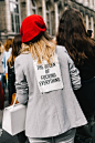 NEED, red beret and a gray blazer, cool caption on the back of the blazer, white structured white tote bag,
