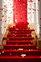 Confetti flowing down the stairs inside a red box, in the style of luxurious interiors, white and gold, piles/stacks, clean and simple designs, decorative borders, wrapped, felt creations