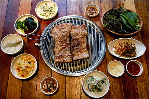 [狎鸥炭火烤肉专业店] 区域：狎鸥亭·清渊洞主要的菜单：葡萄酒 烤肉艺人常去的名店狎鸥亭炭火烤肉专业店，被誉为葡萄食堂。这个可爱的名字还在电视台播放过，明星们介绍喜欢这里的哪道菜。店内装饰成葡萄园，让人有回归自然，畅快惬意的舒适感。