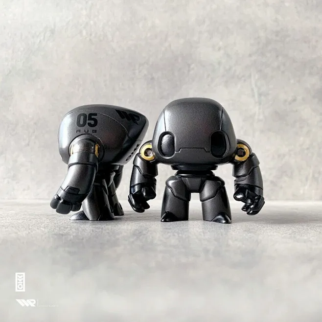This may contain: two black robot figurines sitting next to each other ...