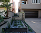 Modern Californian Beach House Hardscape : Custom Industrial Modern Hardscape. Featuring custom Steel planters, LED backlit Stainless Steel address numbers, a poured-in-place concrete wall, and a LED under-lit metal wall cap. Landscaped with