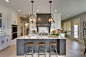 Large transitional l-shaped light wood floor open concept kitchen photo in Minneapolis with an undermount sink, recessed-panel cabinets, white cabinets, quartzite countertops, white backsplash, subway tile backsplash, stainless steel appliances and an isl