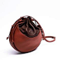 .two brown shades round leather bag