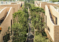 Curving walls wrap blocks in housing complex by UNStudio : Small strips of clay-coloured stone give the undulating facades of the houses in this Beijing development by UNStudio a woven texture