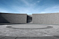 an empty circular concrete area with blue sky in the background