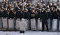 A woman speaks as she kneels down in front of a line of riot police in the center of Kiev on Jan. 24. Ukrainian protesters today expanded their protest camp in Kiev closer to the administration of President Viktor Yanukovych, after crisis talks to end Ukr