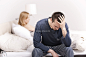 Man sitting on the bed with woman on the back