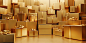 A background wall made of matte gift boxes of golden paper texture of different sizes and shapes, two-point tilted perspective composition, perspective angle, in front of an empty high platform for displaying products, realistic details