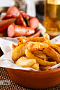 Photograph Fried Potatoes in a bowl, with grilled sausage and beer on backg by Sergey Kotenev on 500px