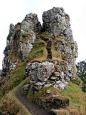 an old stone structure with moss growing on it