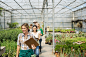 Workers with clipboards walking in greenhouse by Hero Images on 500px