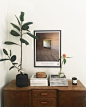 gorgeous dresser top styling- plant, art, stacks of books