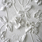Wow! Wall art by Olefir Design.  Something similar to this can be made by gluing silk flowers to a canvas and spray painting it white.  You can also draw out designs around the flowers with glue before painting.: 