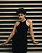 woman wears black halter dress